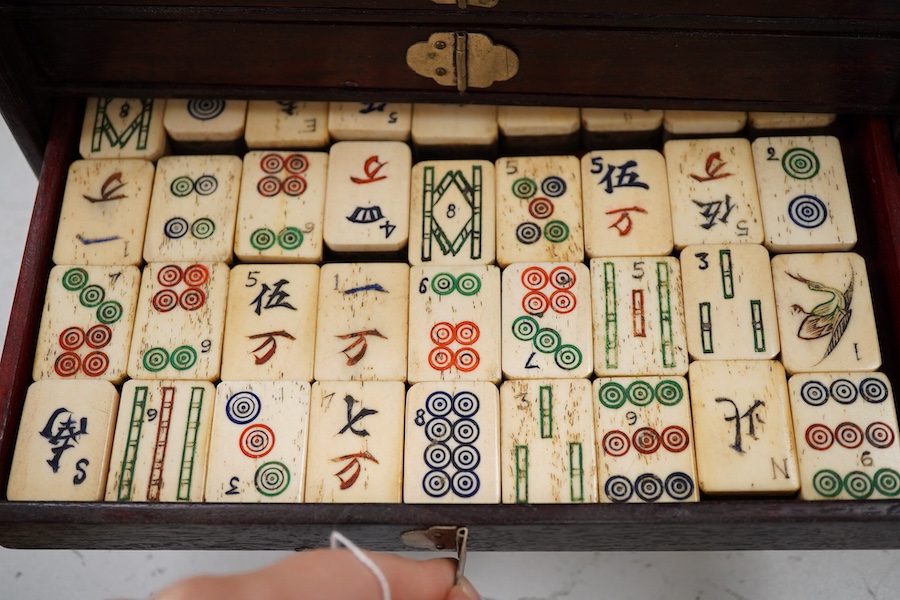 A Chinese bone and bamboo Mah-Jong set, 24cm wide